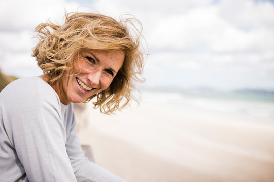 Happy blond woman enjoying at beach