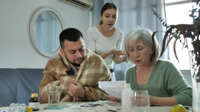 Elderly mother carefully reads the annotation to the medicines. High quality 4k footage