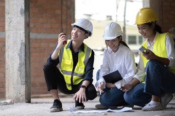 Professional Construction and Engineer team Working on workplace. Professional black architect and construction worker working look at blueprint plan on site.