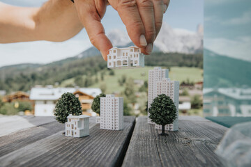 Hand of engineer positioning model home on table