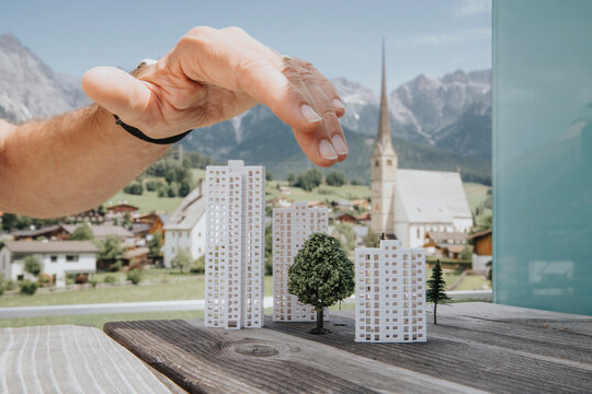 Hand of engineer over building models
