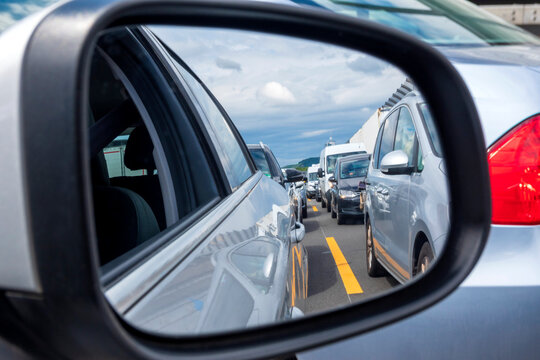 Traffic jam reflecting in side-view mirror