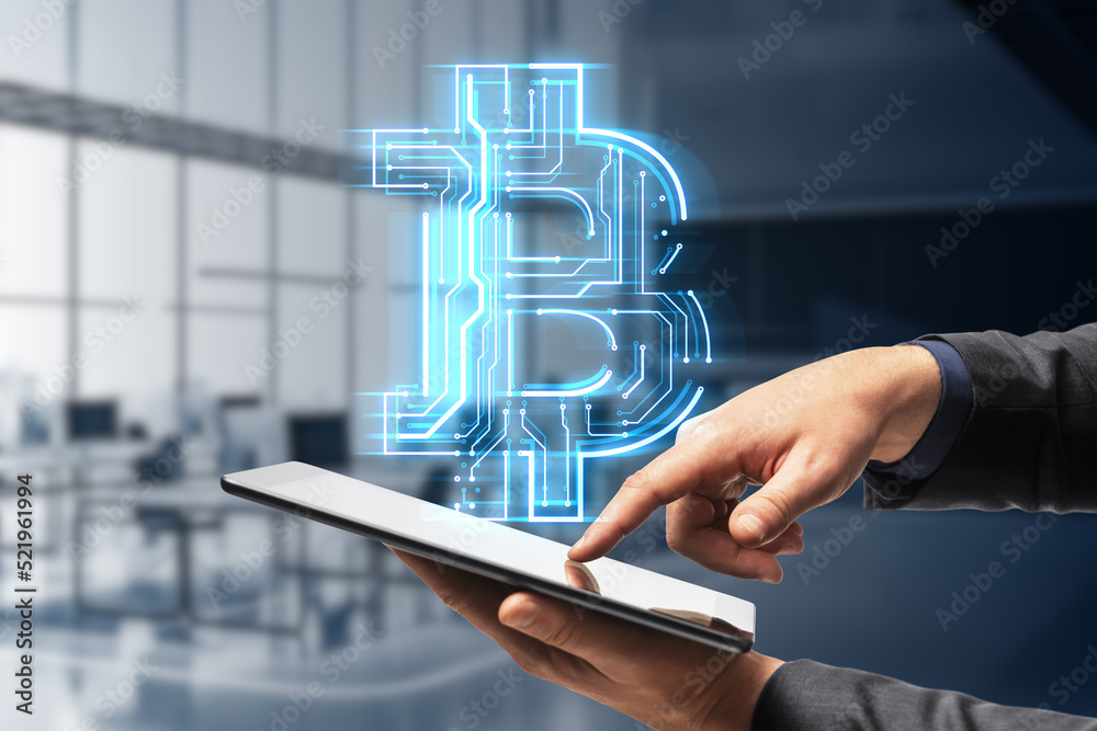 Poster businessman hand pointing at tablet or smartphone with creative glowing bitcoin circuit hologram on 