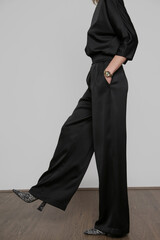 Serie of studio photos of young female model wearing all black classic basic outfit, silk satin...