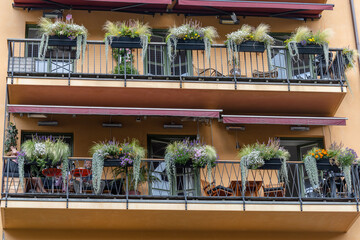 Stockholm, Sweden Aug 7, 2022 A pair of ornate balconies with plants on   a building.