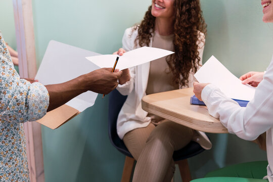 Businessman handing over document to colleague in office
