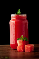 Close-up of organic fresh chilled Watermelon juice garnished with min leaf in studio light