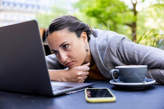 Sad businesswoman looking at laptop