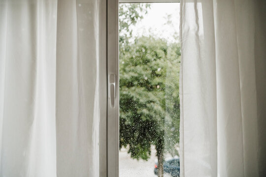 Raindrops on window seen through glass