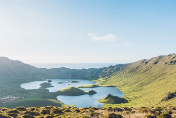 Idyllic view of lake amidst hills on sunny day at Corvo Island, Azores, Portugal