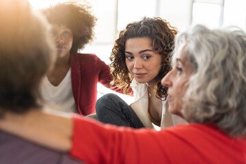 Young businesswoman looking at senior colleague discussing strategy