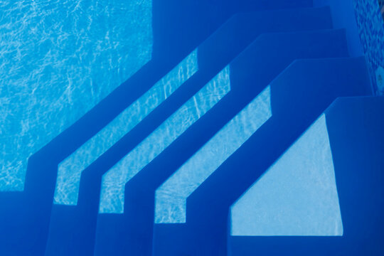 Steps in swimming pool on sunny day