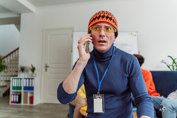 Businessman talking on mobile phone in office