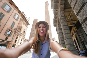 Attractive tourist girl takes self portrait with Bologna Two Towers landmark, Italy © zigres