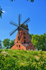 Obraz na płótnie Canvas A brick Dutch windmill from the 19th century in Stara Różanka, Warmian-Masurian Voivodeship, Poland