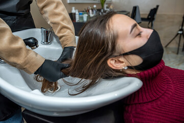 Fototapeta premium qualified serious steamer prepares his regular client for washing his head in the new salon