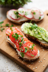 Different sandwiches with vegetables and microgreens