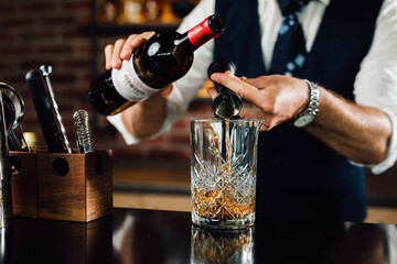 close up of barman preparing drinks in bar