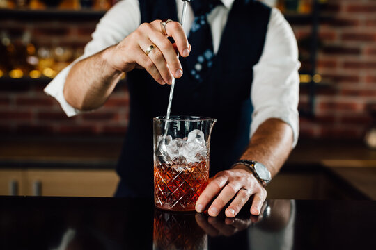 closeup of barman mixing cocktail