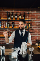 waiter cleaning glass in club