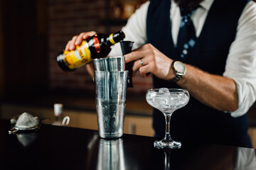 close up of barkeeper preparing drinks in nightclub