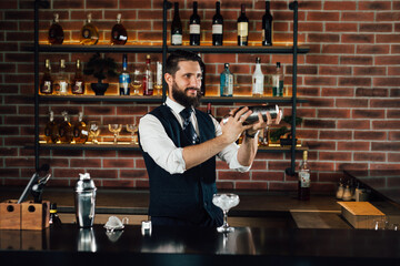 close up of barkeeper preparing cocktail in nightclub