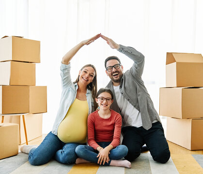 child family box home house moving happy apartment pregnant mother father daughter relocation new property parent pregnancy roof hand mortgage insurance protection built