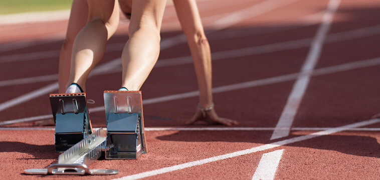 Back view of female feet on starting block ready for a sprint start