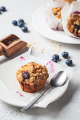 Vegan oatmeal, banana, blueberry muffins on gray background. Plant based dessert.