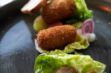 Dutch fast food, deep fried croquettes filled with ground beef meat and served with green salad