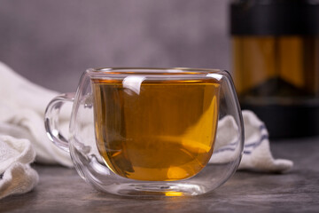 Green tea. Green tea brewed with French press on a dark background. Healthy drinks. Herbal tea concept. close up