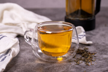 Green tea. Green tea brewed with French press on a dark background. Healthy drinks. Herbal tea concept. close up
