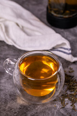 Green tea. Green tea brewed with French press on a dark background. Healthy drinks. Herbal tea concept. close up