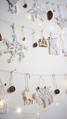 Eco friendly homemade DIY macrame Christmas decor with wooden figurines, natural materials on the wall. Concept: eco-friendly zero waste christmas tree. Winter holidays. Macrame Christmas decor 