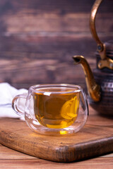 Green tea. Green tea brewed with copper teapot on stone background. Healthy drinks. Herbal tea concept. close up