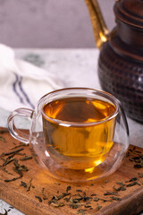 Green tea. Green tea brewed with copper teapot on stone background. Healthy drinks. Herbal tea concept. close up