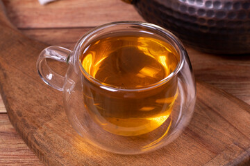 Green tea. Green tea brewed with copper teapot on stone background. Healthy drinks. Herbal tea concept. close up