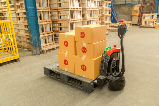 Cargo Box with Hand Pallet Truck in warehouse or storehouse inventory product stock for storage logistic background. retail box on shelf in large industrial plants for storing products.