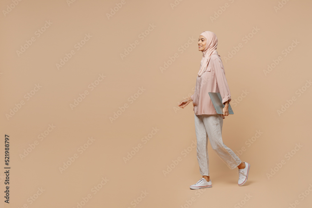 Canvas Prints full body side view happy young arabian asian muslim woman she wear abaya hijab pink clothes hold cl