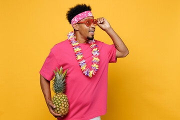 Young happy fun man he wear pink t-shirt hawaiian lei glasses near hotel pool look aside on...