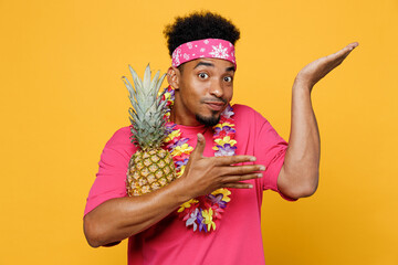 Young fun cool cheerful man 20s he wearing pink t-shirt hawaiian lei near hotel pool holding...