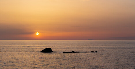 Fototapeta na wymiar sunset over the sea with rocks in Ischia Forio