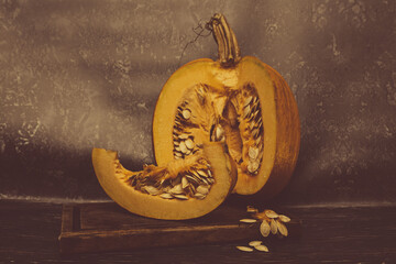 Cutaway pumpkin with berry slice and seeds with copy space in dark style