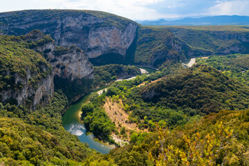 Ardèche river canyon panorama in Provence southern France seen from the view point “Belvédère du Serre de Tourre“ on a sunny summer day. Tourist destination famous for steep rock cliffs and kayaking