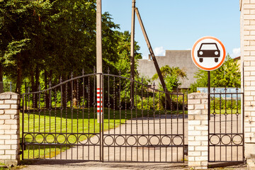 Metal gates and road sign prohibiting entry for transport