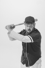 Fighting spirit. Emotional male baseball player wearing retro sports uniform and holding bat isolated on white background. Vintage baseball batter