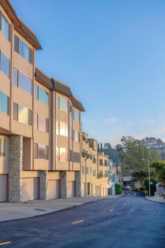 Row of apartment buildings with attached garages near the road in San Francisco, CA