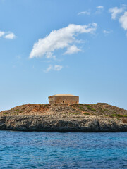 Fototapeta na wymiar Old circular historic defensive bunker on the coast of Menorca, Spain