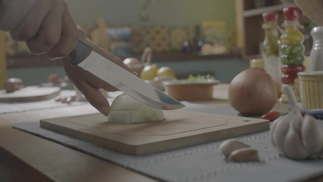 ungraded cutting onion, dicing onion in a wood cutting board, mise en place onion, handheld camera