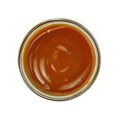 Sweet caramel sauce in a transparent bowl isolated on white background close up. Golden Butterscotch toffee caramel liquid. Melted caramel sauce drop.